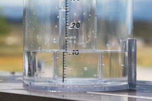 A clear rain gauge holds 10cm of rain